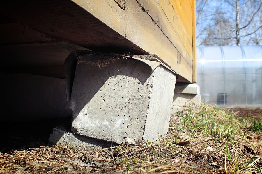 a close up of a concrete block under a building