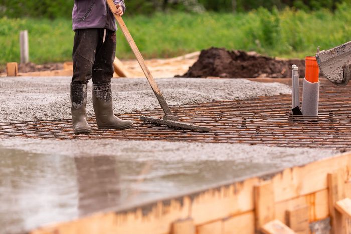 a man with a shovel is standing on a construction site