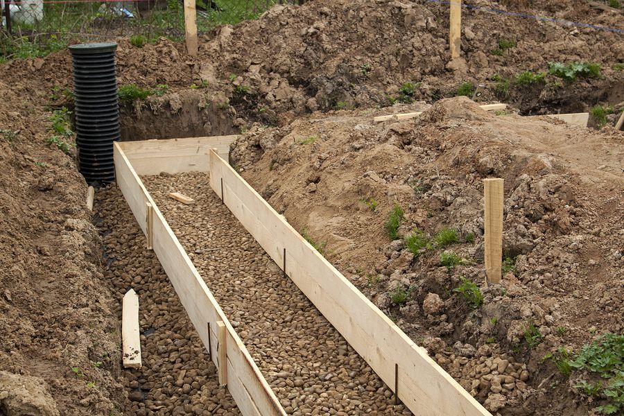 a wooden box filled with dirt next to a pile of dirt