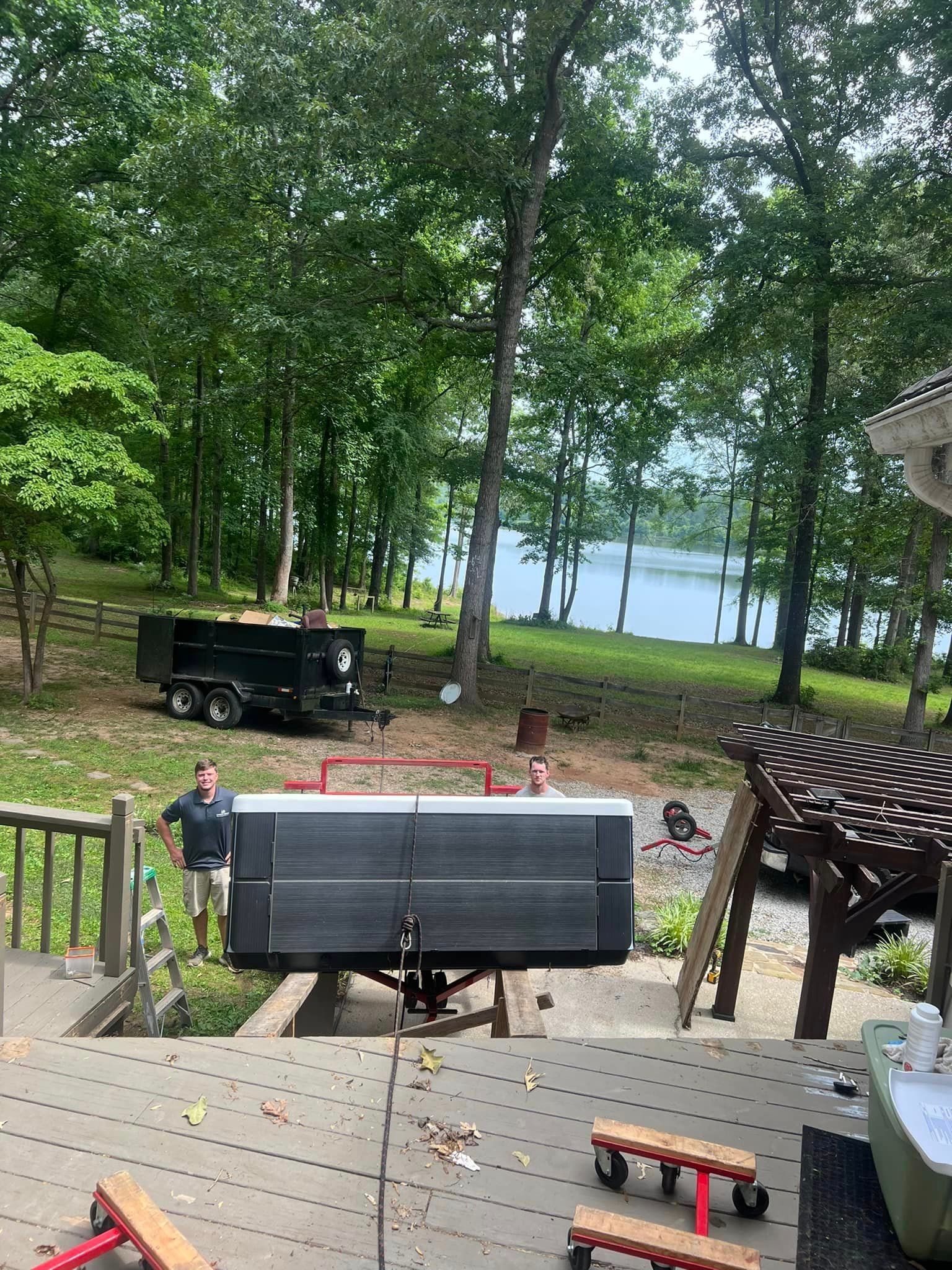 A man is standing on a deck next to a trailer.