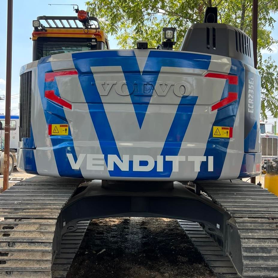 A blue and white volvo venditti construction vehicle