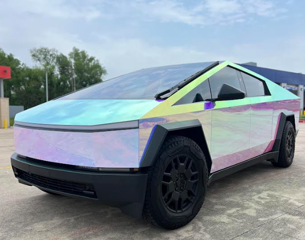 A tesla cybertruck is parked in a parking lot