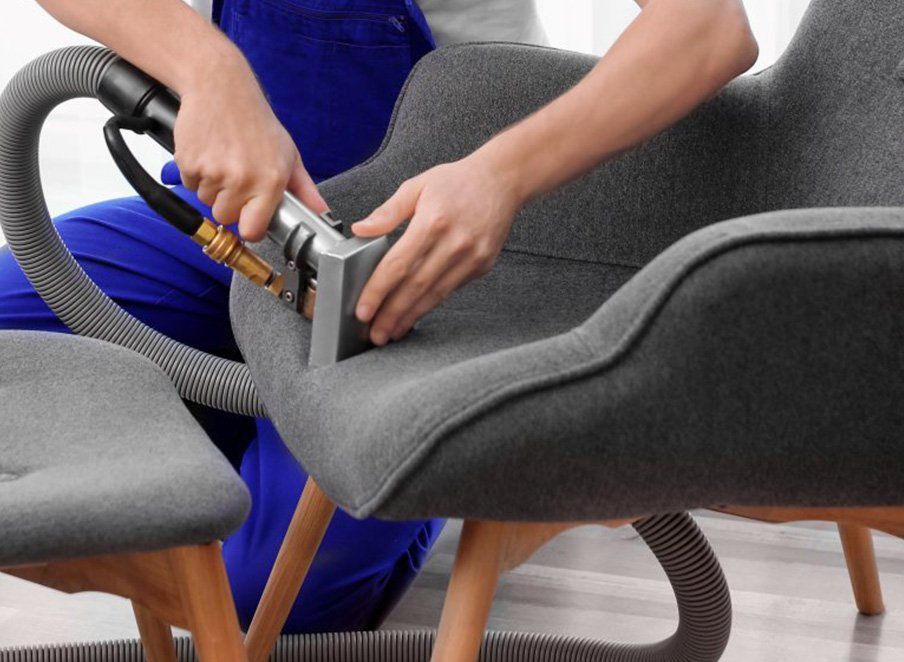 Man cleaning upholstery — Tile & Carpet Cleaning in Wollongong, NSW