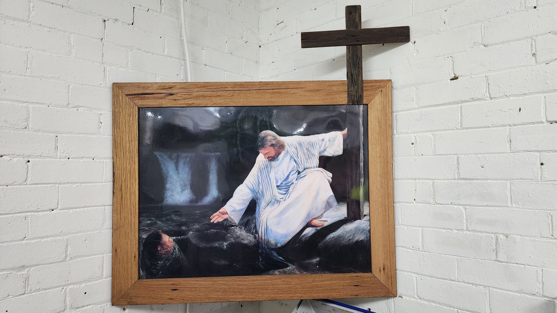 Picture of Jesus reaching down to help rescue someone.