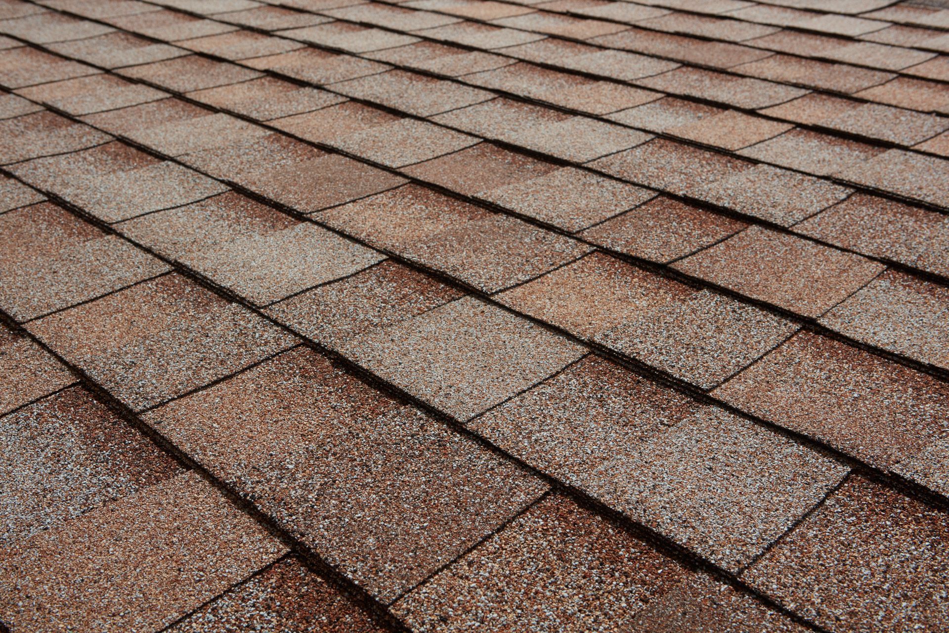 Close-up of brown asphalt roof shingles.