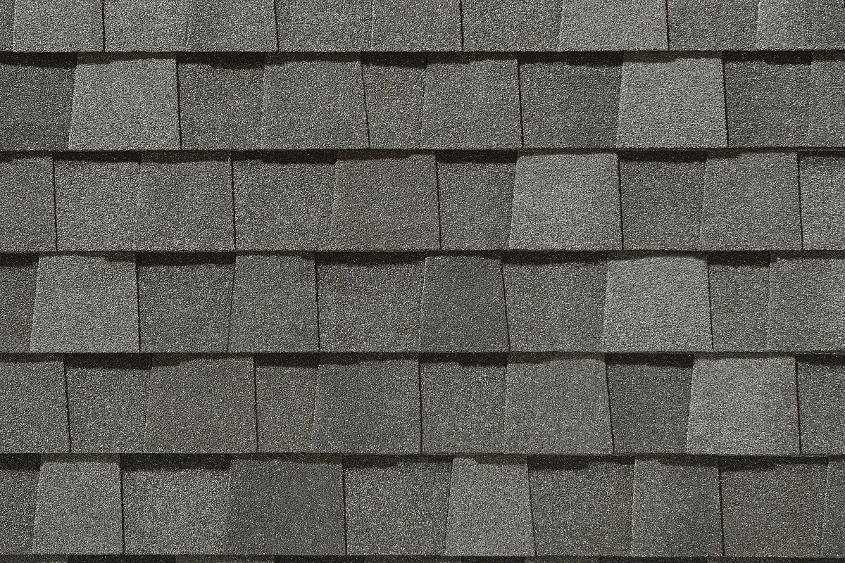 Dark gray asphalt roof shingles in a repeating pattern.