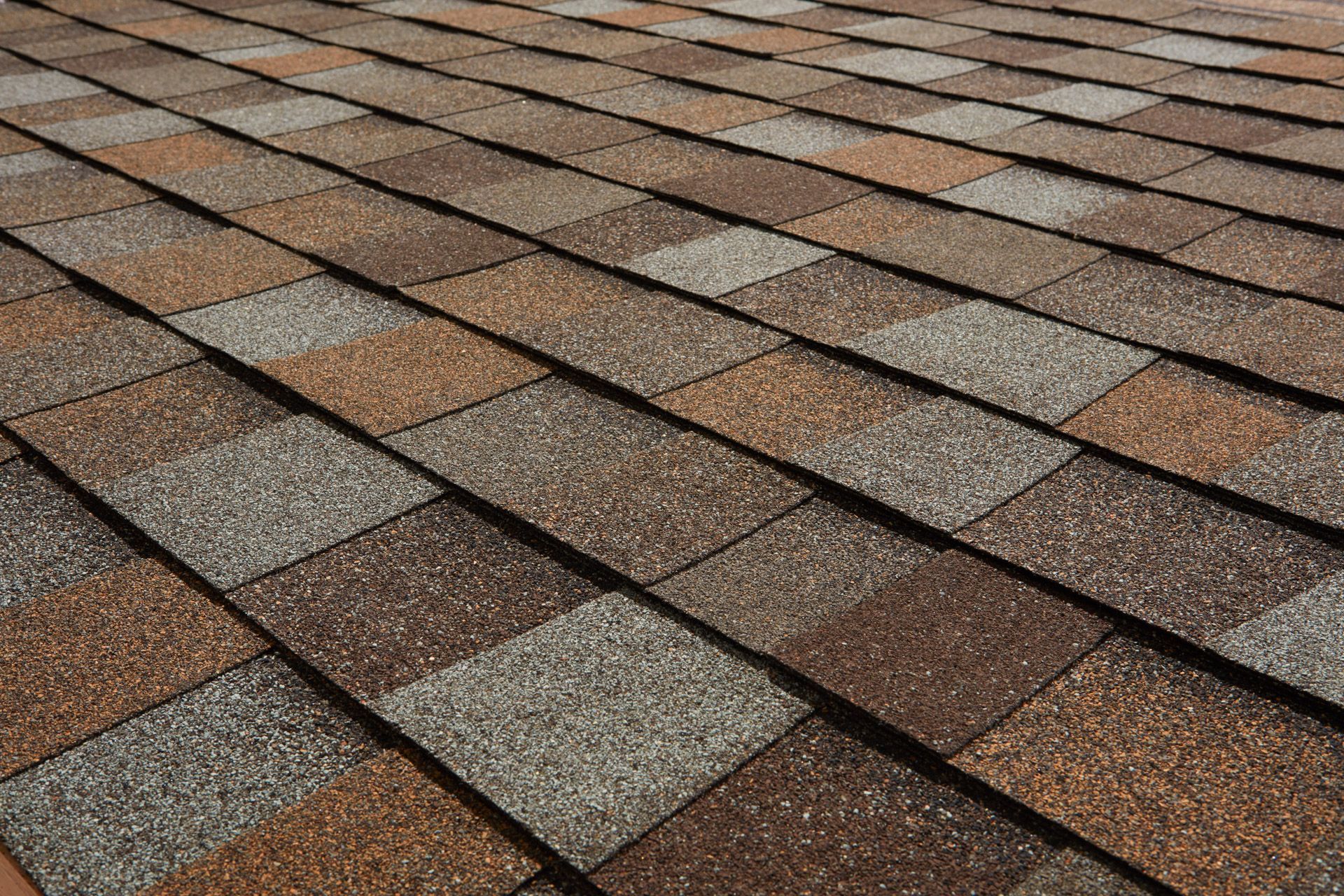 Asphalt shingle roof with varied brown, tan, and gray colors.