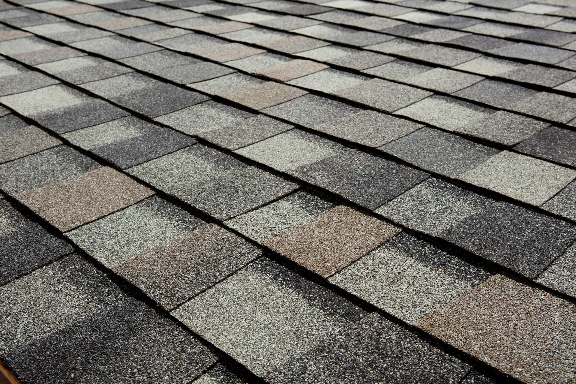 Close-up of a multi-colored asphalt shingle roof.