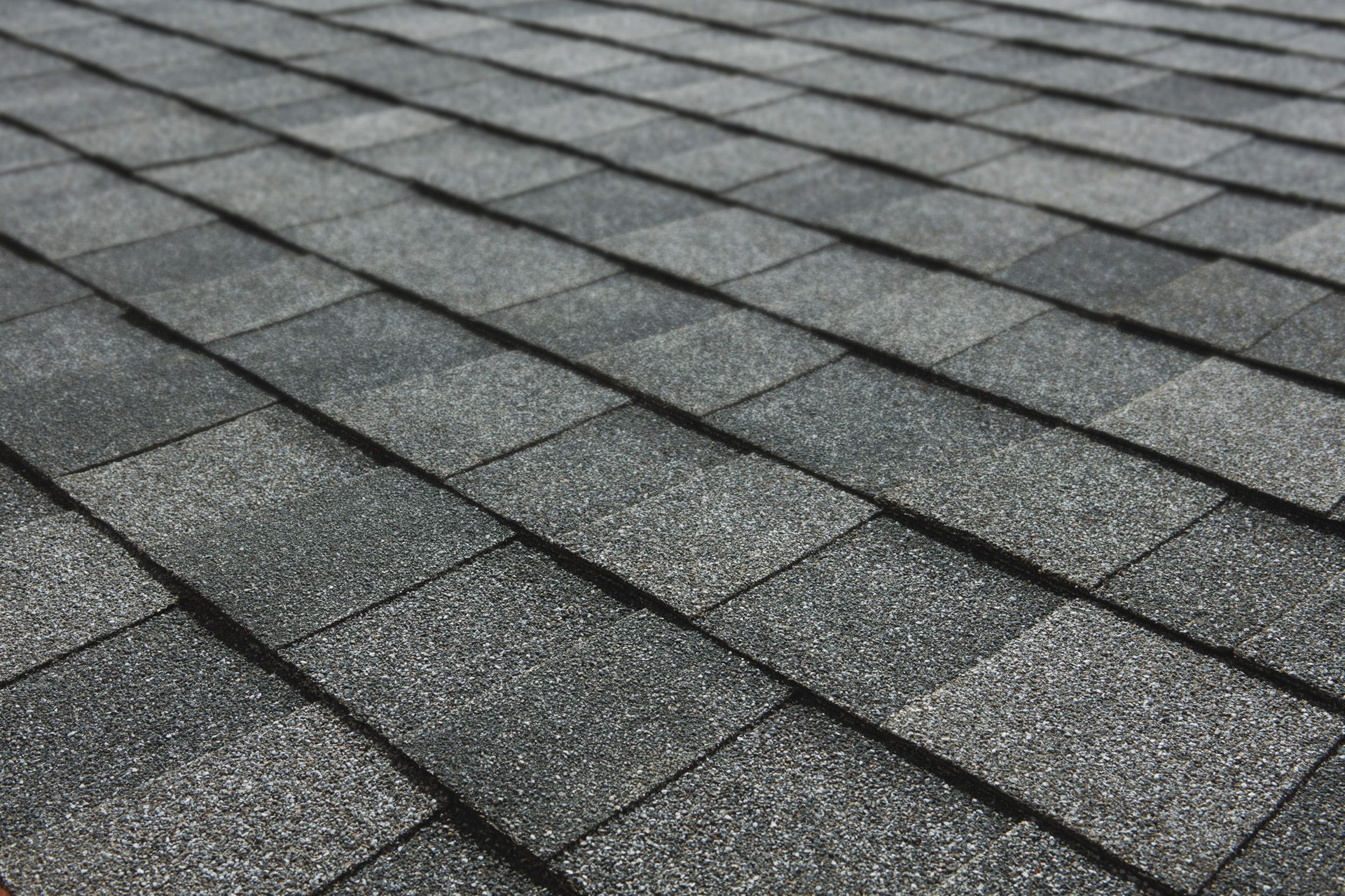 Close-up of a gray asphalt shingle roof.