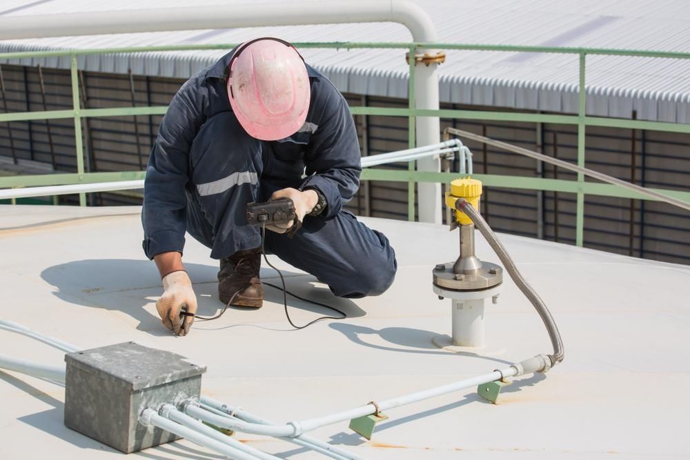 A Man is Inspecting the Roof — Stephen Meaker Roofing in Wagga Wagga, NSW