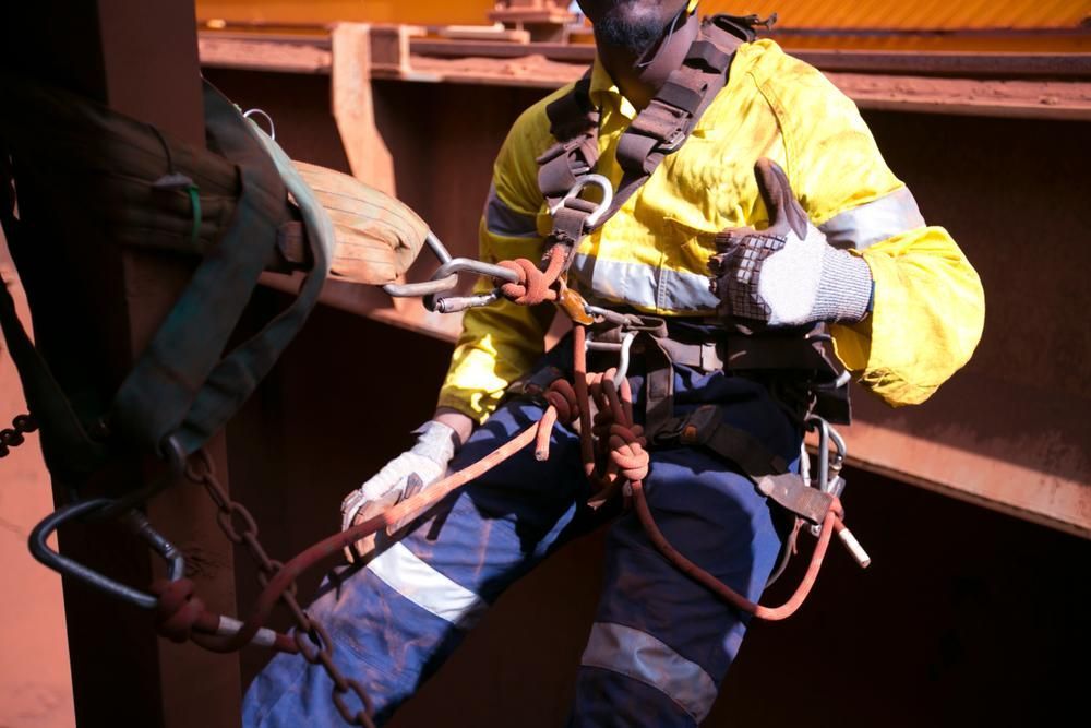 A Man Wearing Safety Gear During Roof Inspection — Stephen Meaker Roofing in Wagga Wagga, NSW