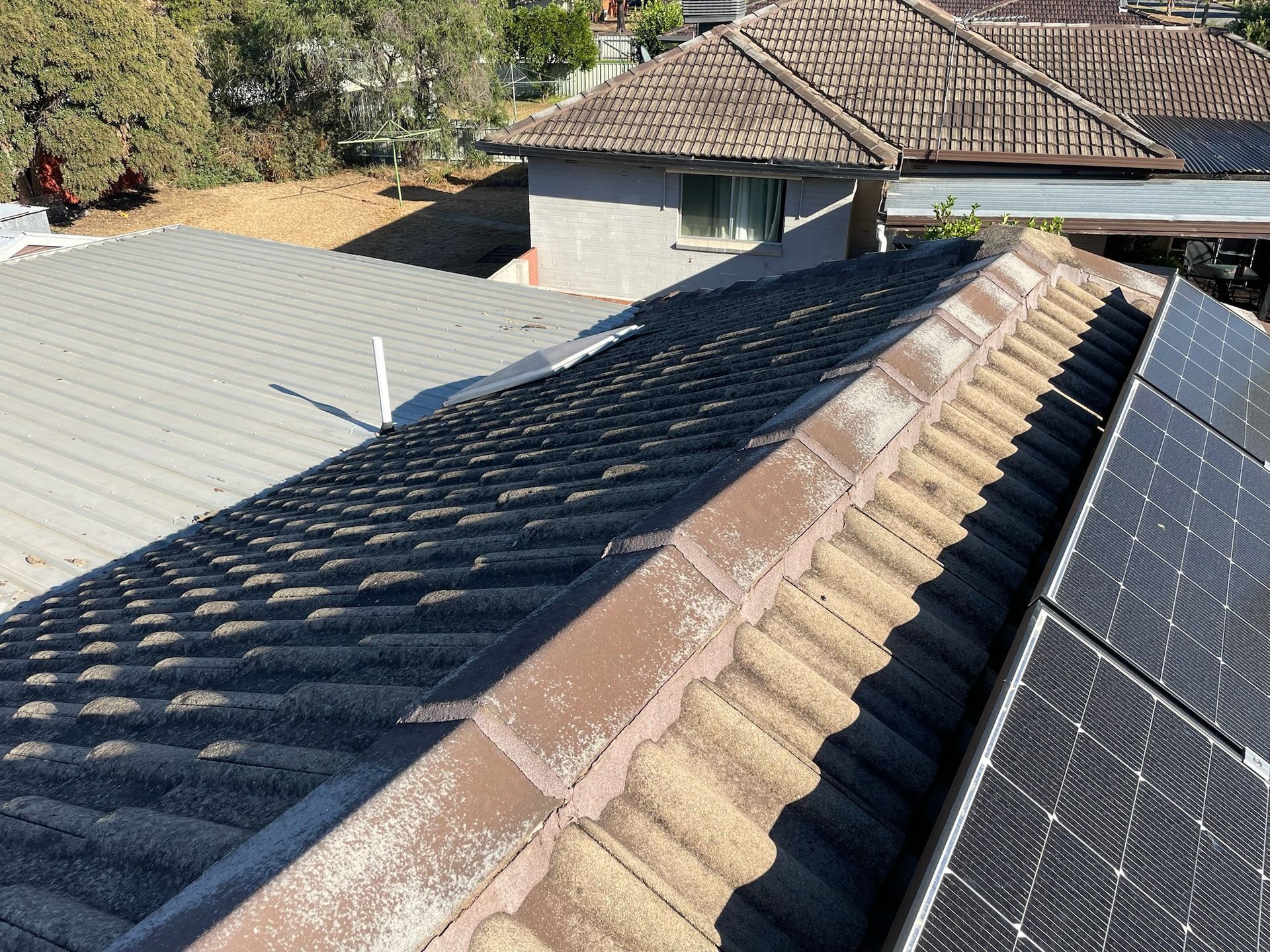An Aerial View of a White House With a Gray Tiled Roof — Stephen Meaker Roofing in Wagga Wagga, NSW