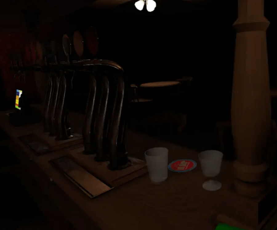 A row of beer taps are lined up in a dark room