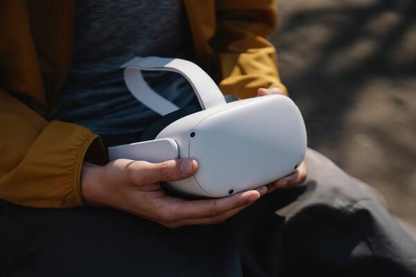 A person is holding a virtual reality headset in their hands.