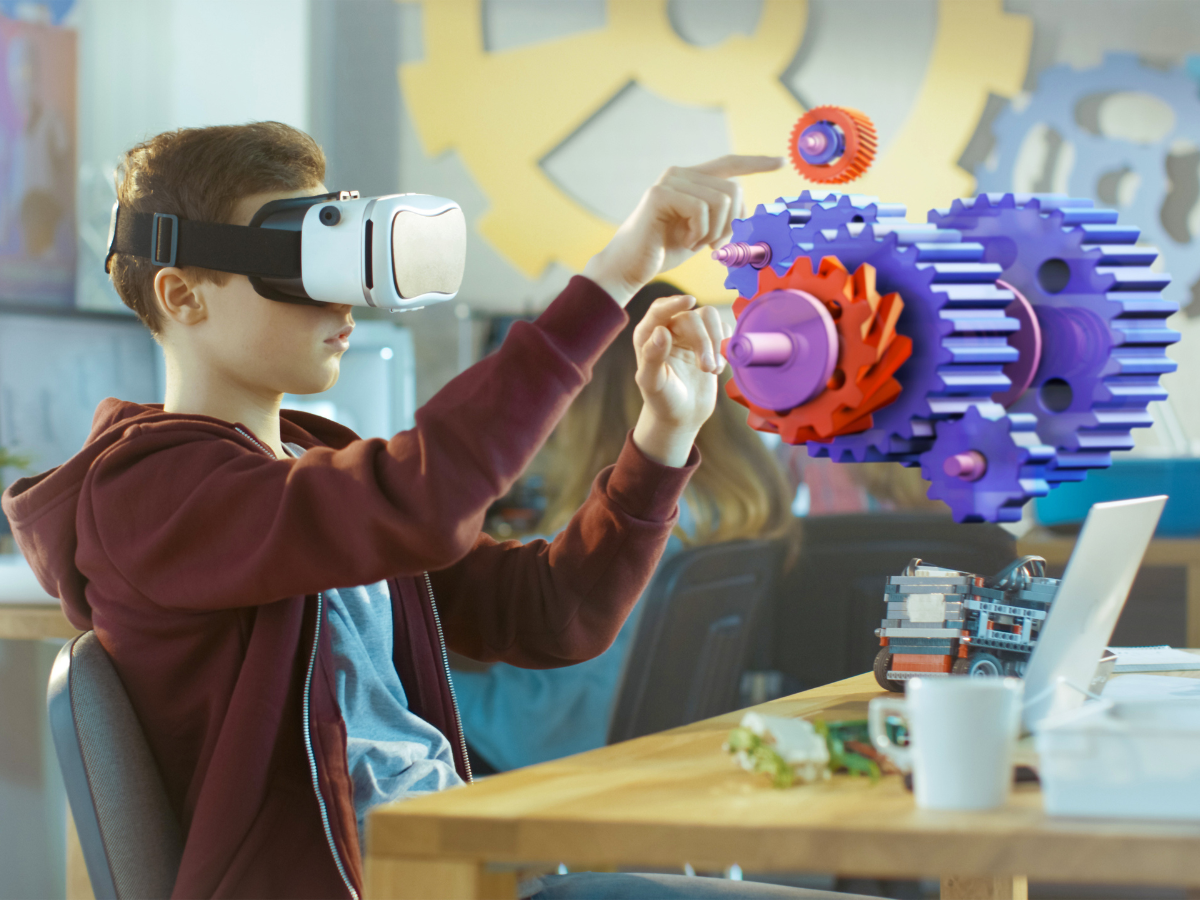 An image of a boy is using the Bit Space Development XR solutions VR headset to learn with gears in school.