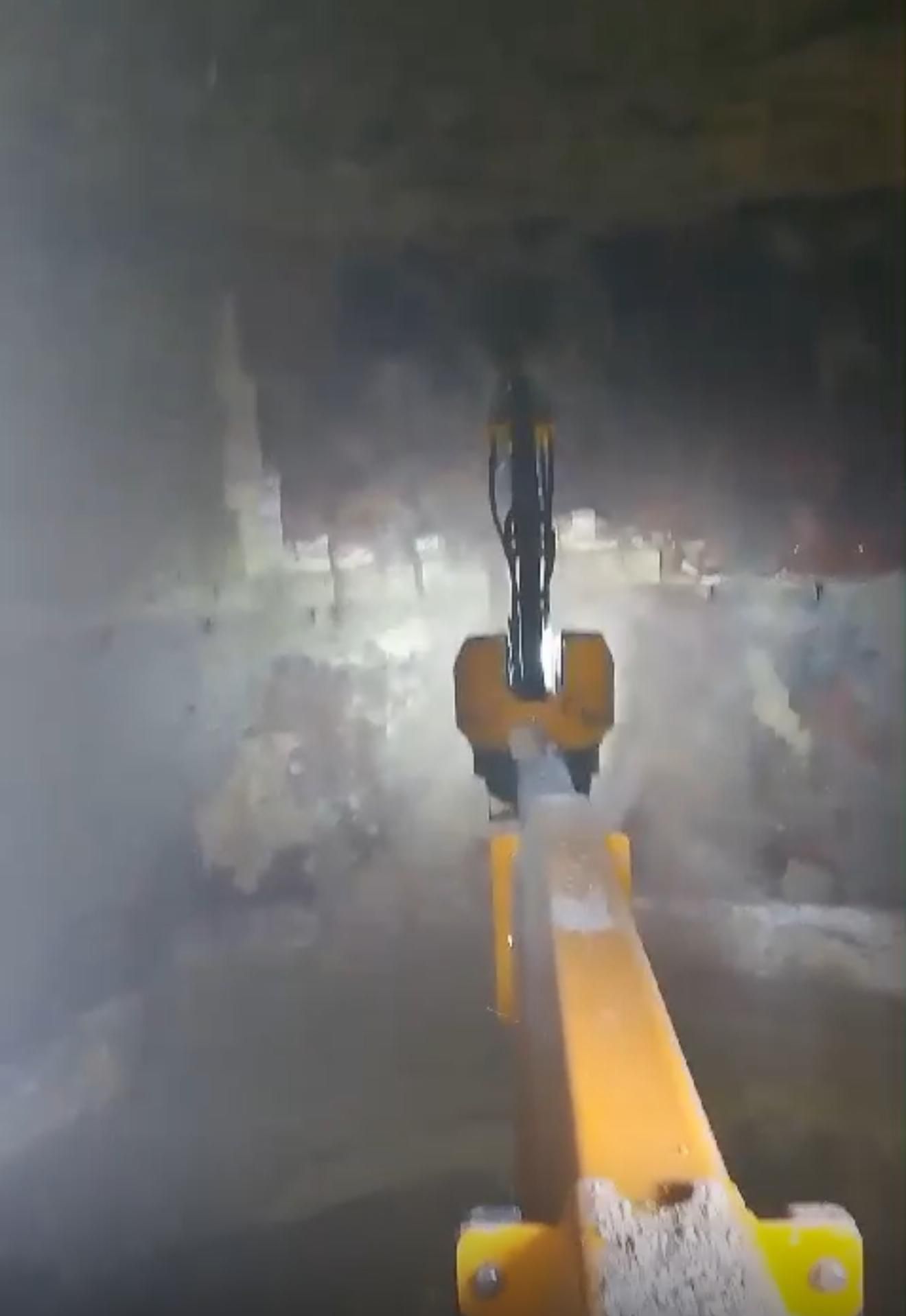 A yellow vacuum cleaner is sitting in the middle of a tunnel.