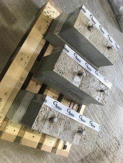 A group of concrete blocks sitting on top of a wooden pallet.