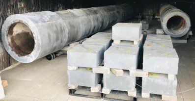 A large pipe is sitting on top of a pile of concrete blocks.