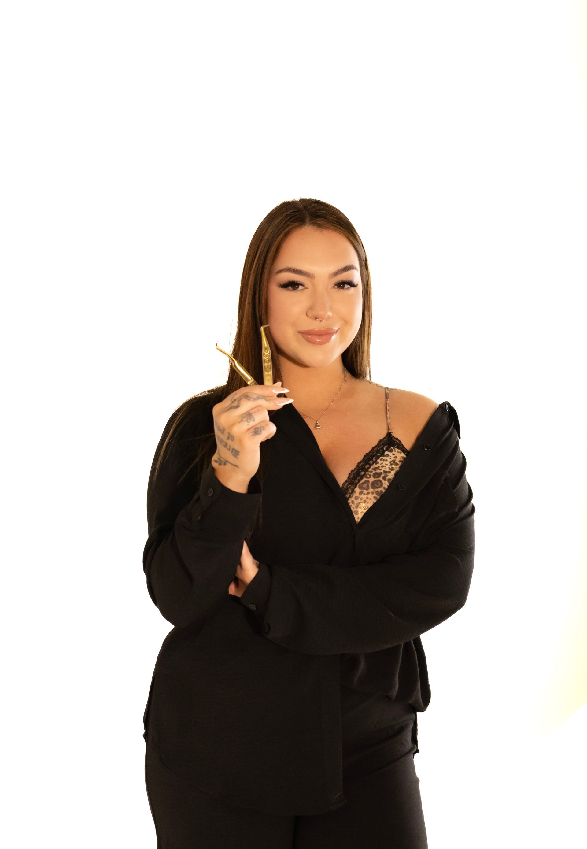 A woman in a black jacket is holding a pair of scissors.