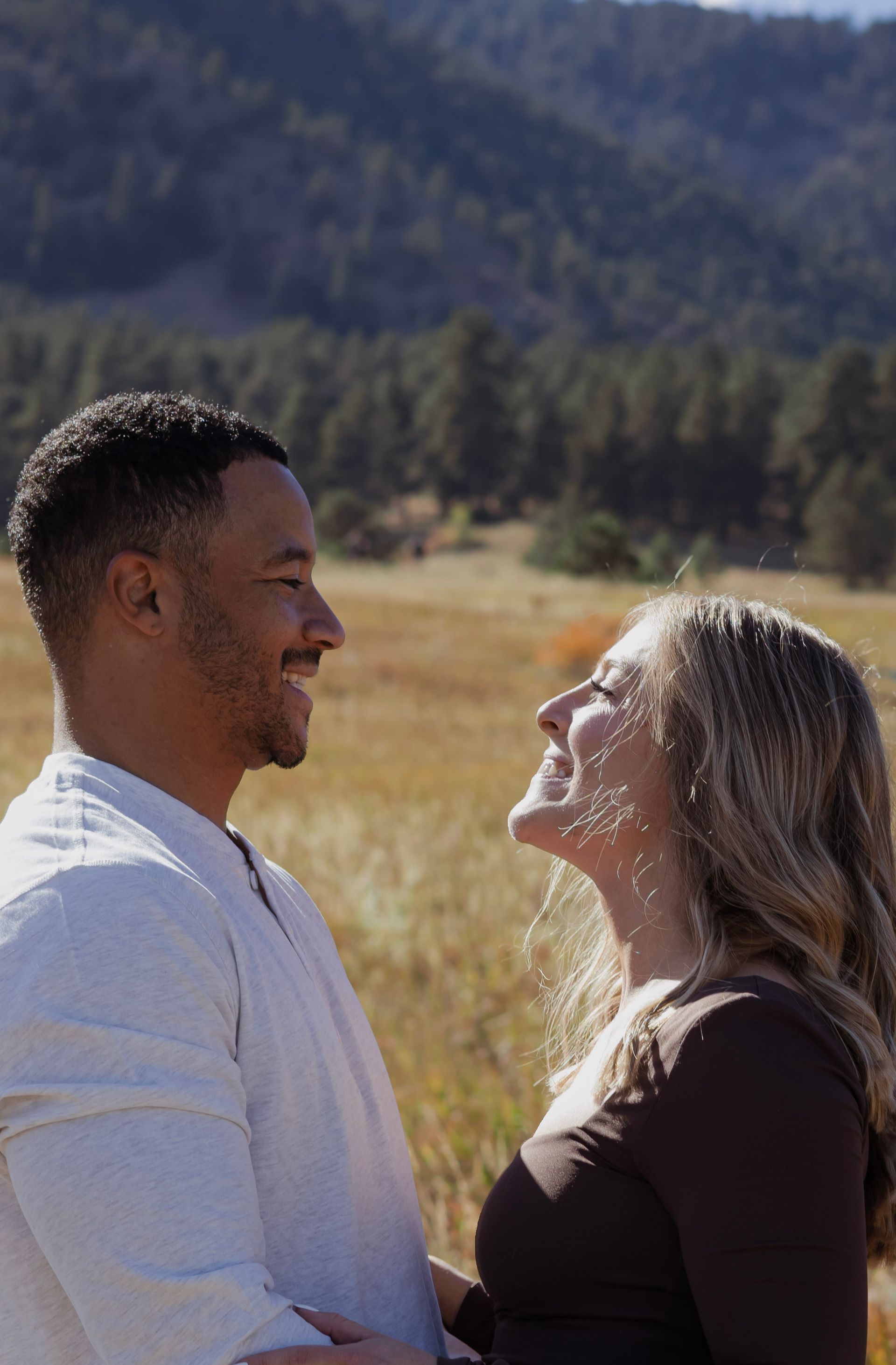 A man and a woman are looking at each other in a field.