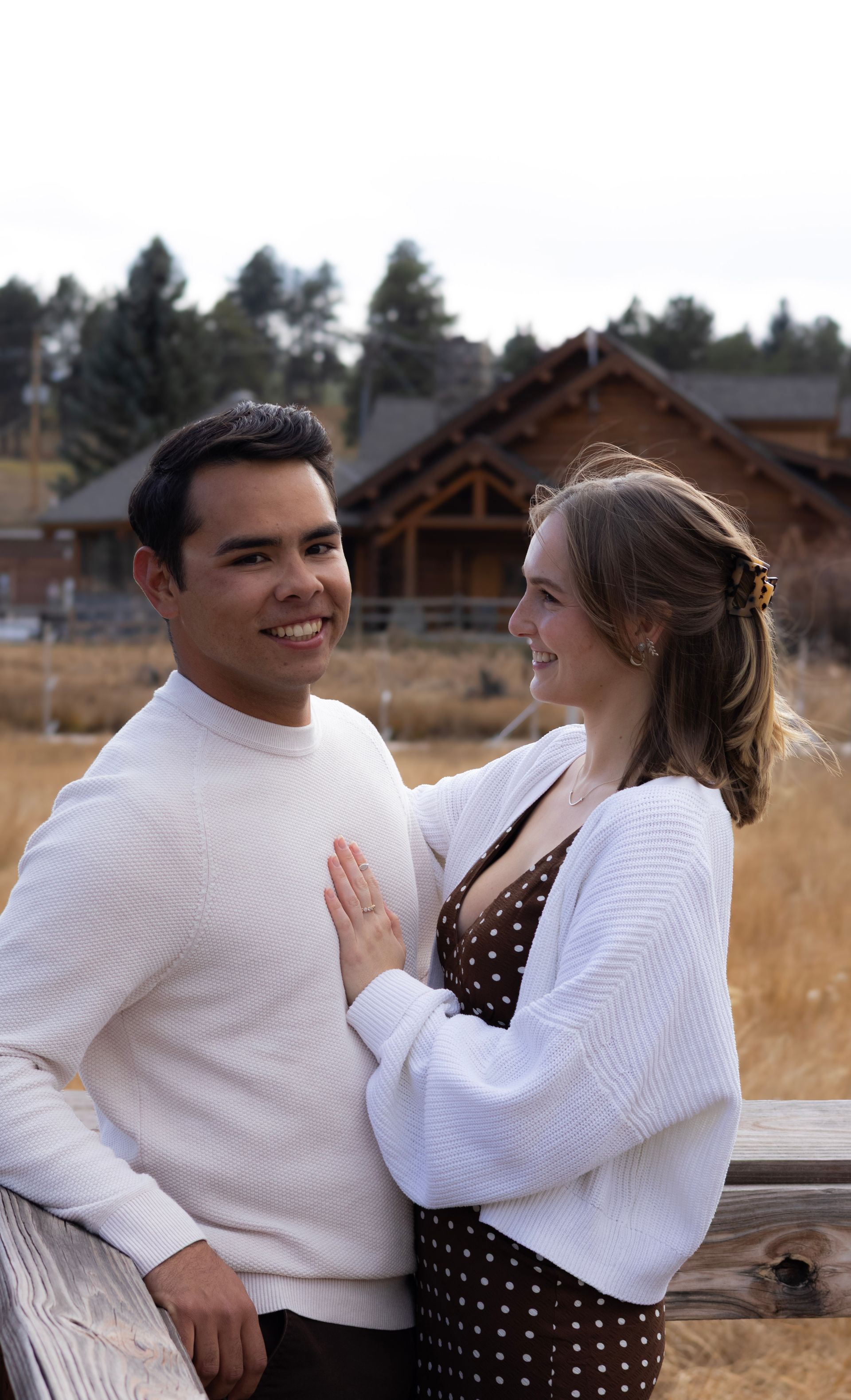 A man and a woman are standing next to each other and smiling.