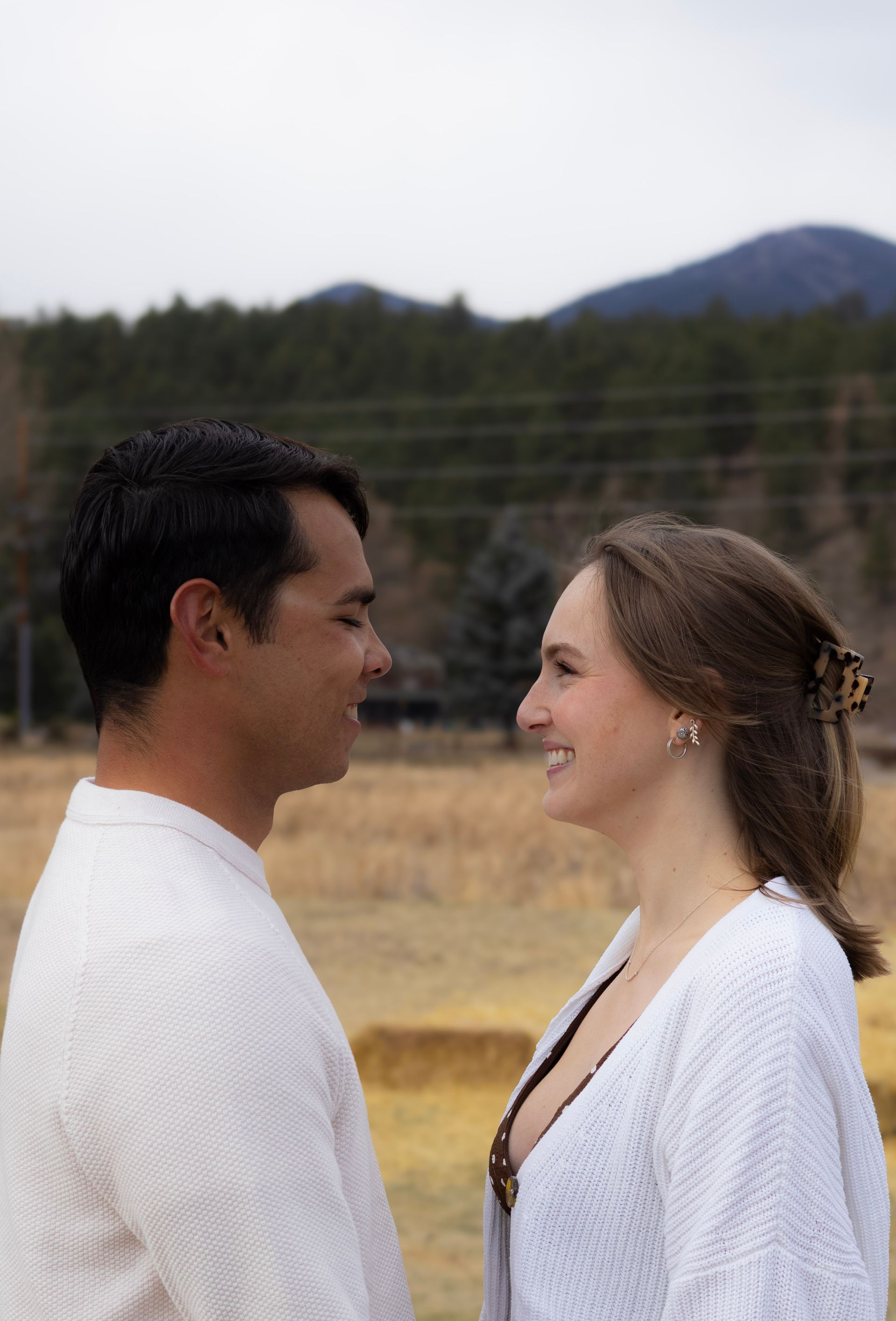 A man and a woman are looking at each other in a field.