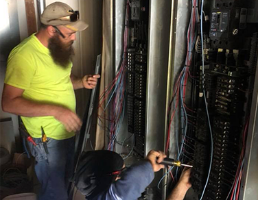 Two Electrical Technician Working On Electrical Wires