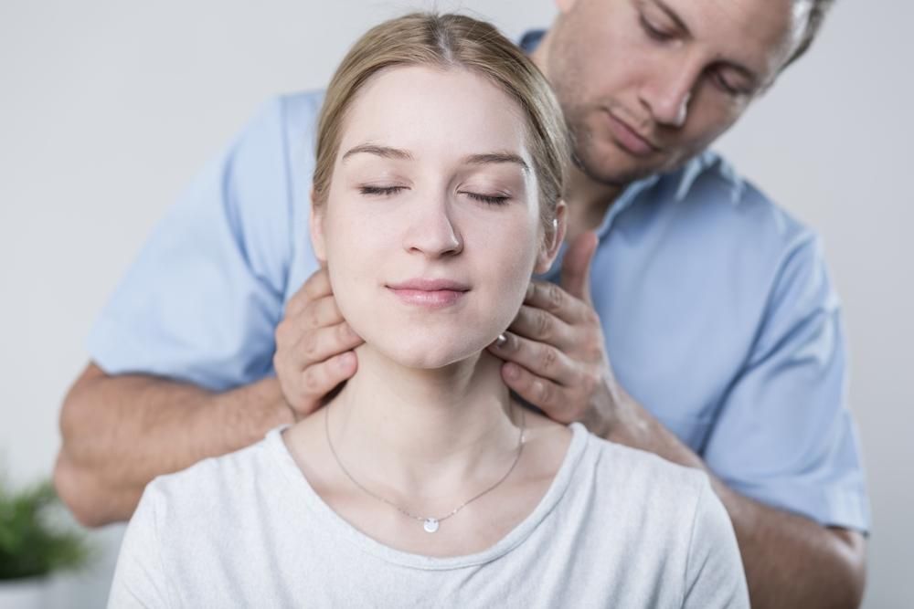 A Man Is Giving A Woman A Neck Massage — Pin Point Remedial Massage In Lammermoor, QLD