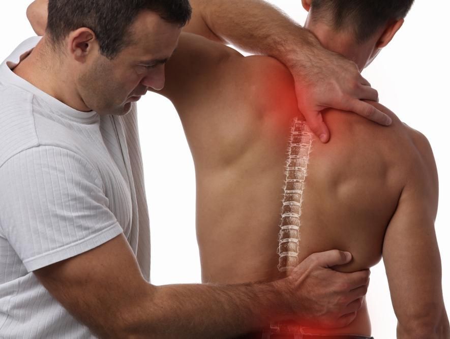 A Man Is Giving A Back Massage To Another Man — Pin Point Remedial Massage In Lammermoor, QLD