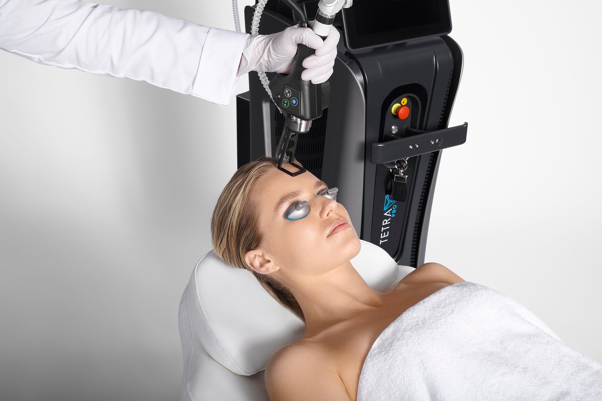Person receiving a facial treatment with a handheld device in a spa clinic