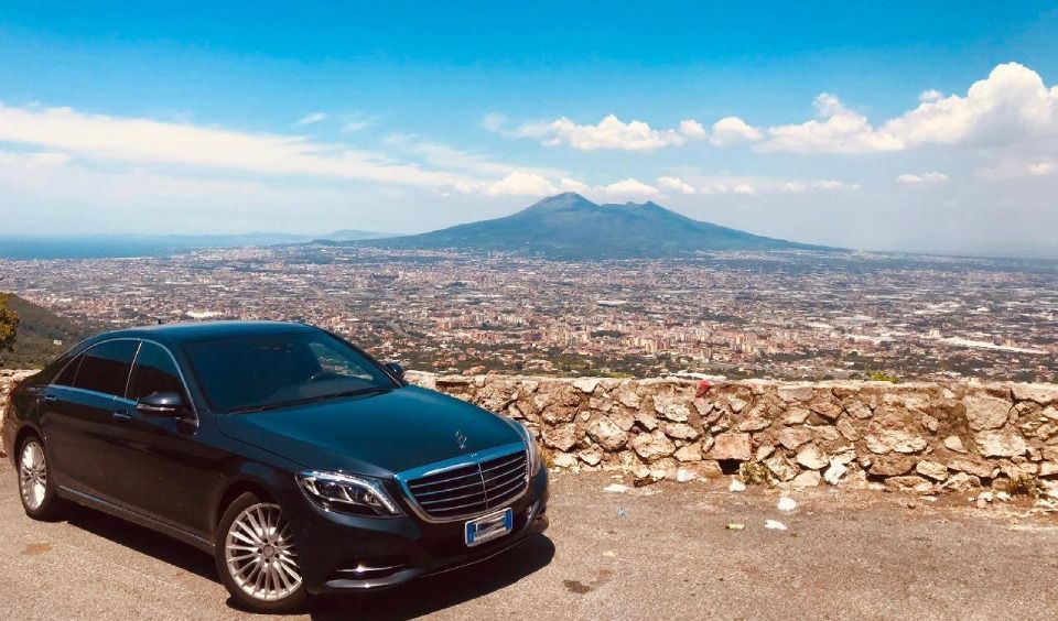 black Mercedes car in front of a belvedere lookout