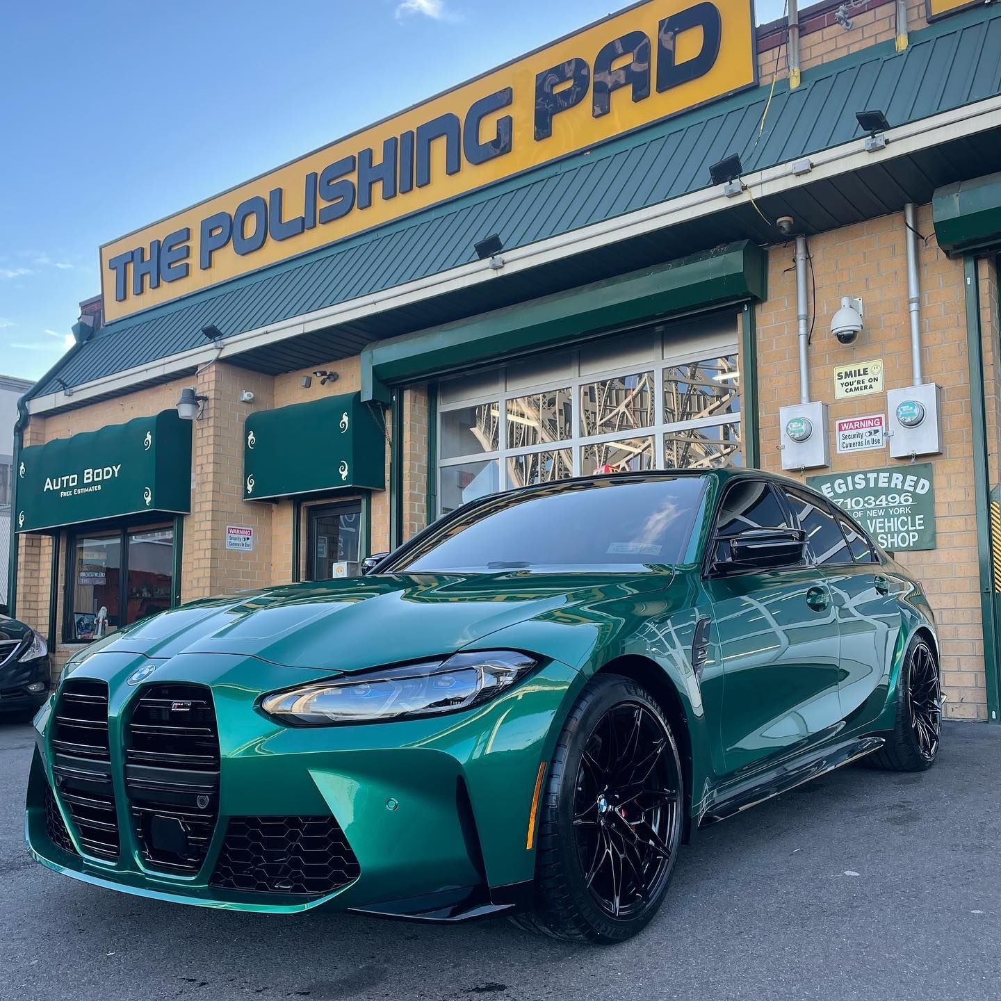 Auto Body Repair & Painting — Mechanic Examining Car Wheel in Staten Island, NY Auto Body Repair & Painting — Mechanic Examining Car Wheel in Staten Island, NY