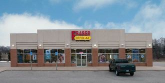 Fraser Optical store front with a dark green truck parked in front; clear sky.