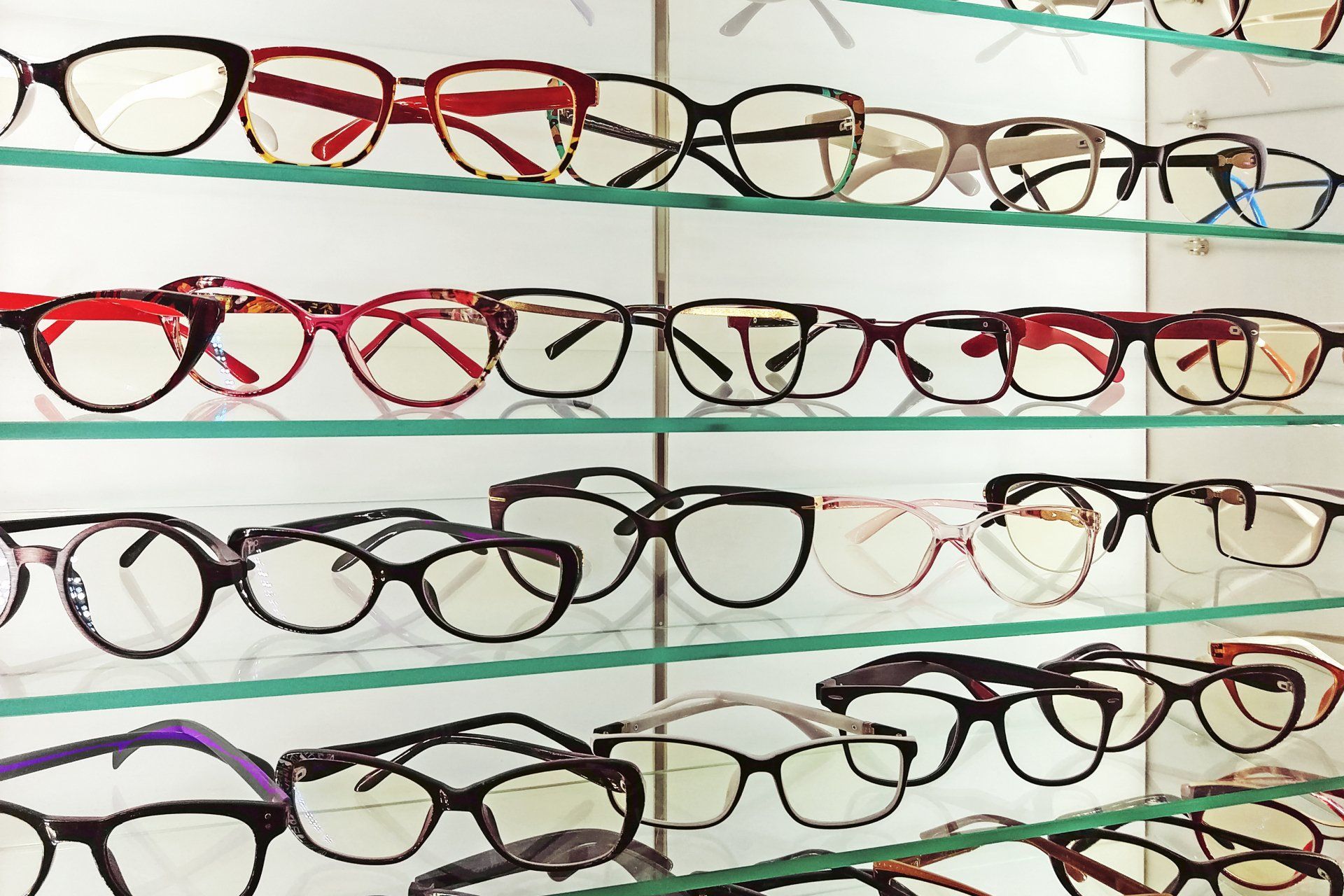 Eyeglass frames displayed on shelves in an optical store. Various shapes, colors, and styles. Eyeglass frames displayed on shelves in an optical store. Various shapes, colors, and styles.