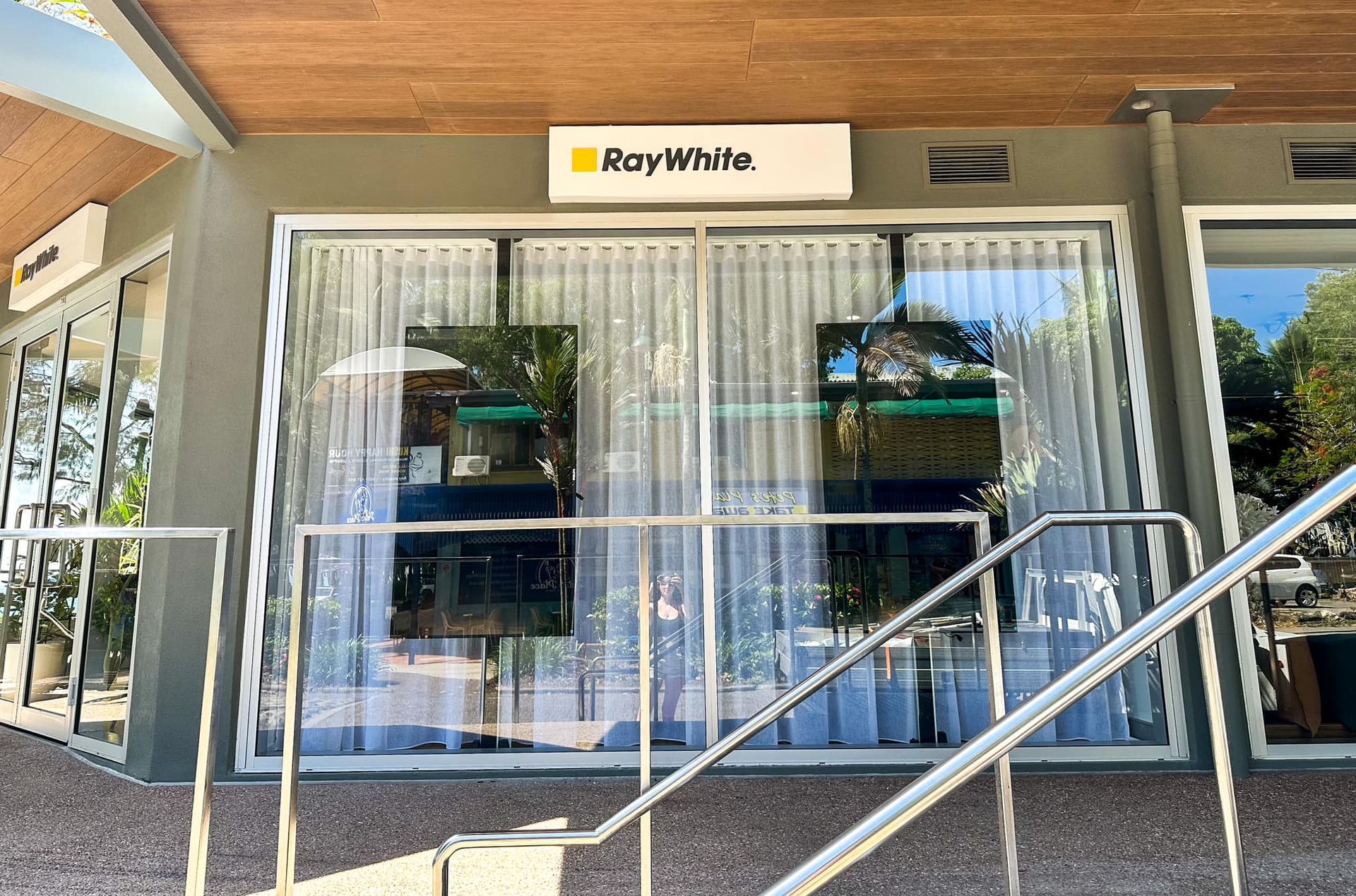 Ray White Real Estate Office With Glass Windows, Sign, and Metal Handrail — Millard Signs in Portsmith, QLD