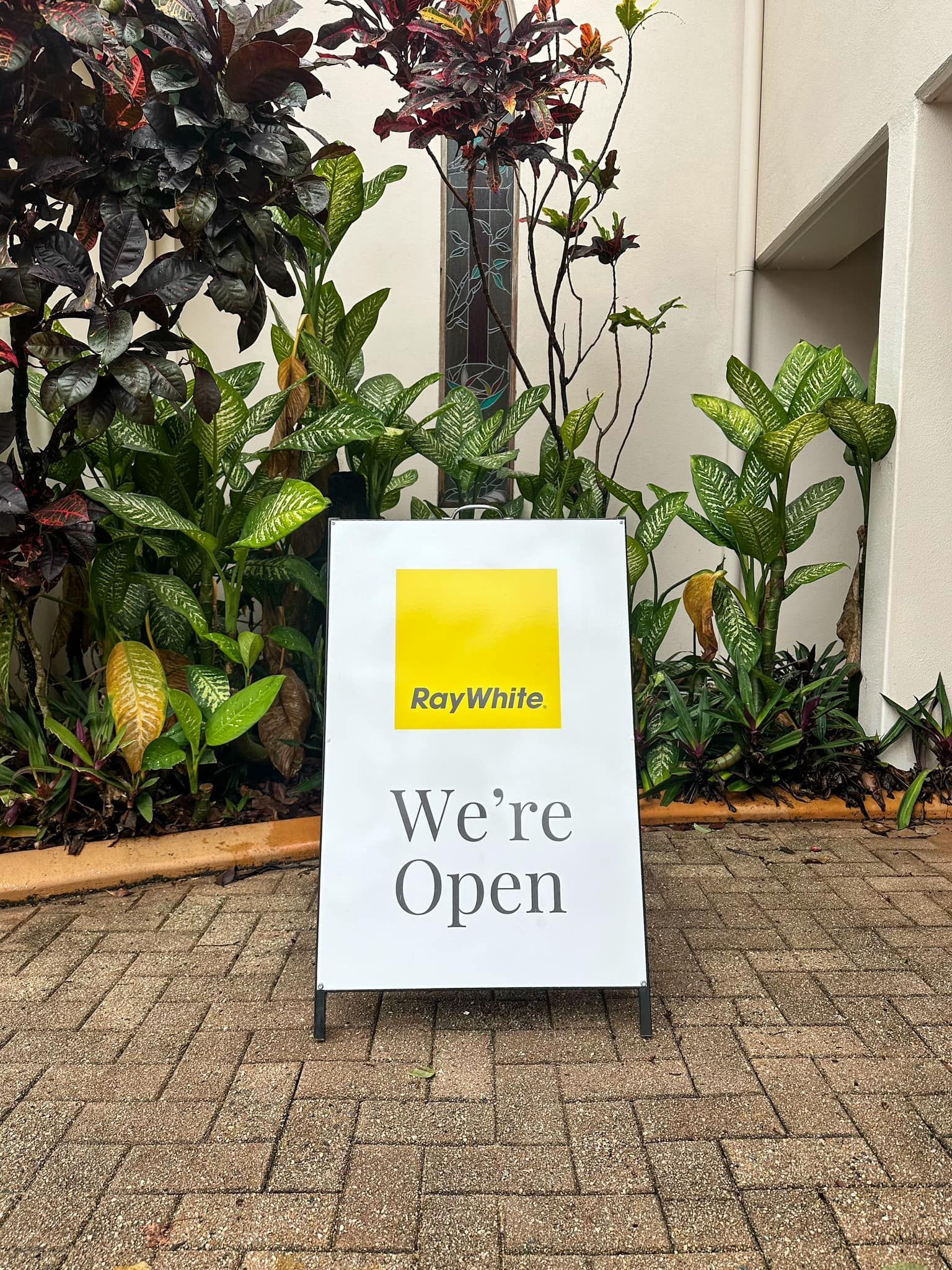 White Sign With a Yellow Square Logo — Millard Signs in Portsmith, QLD