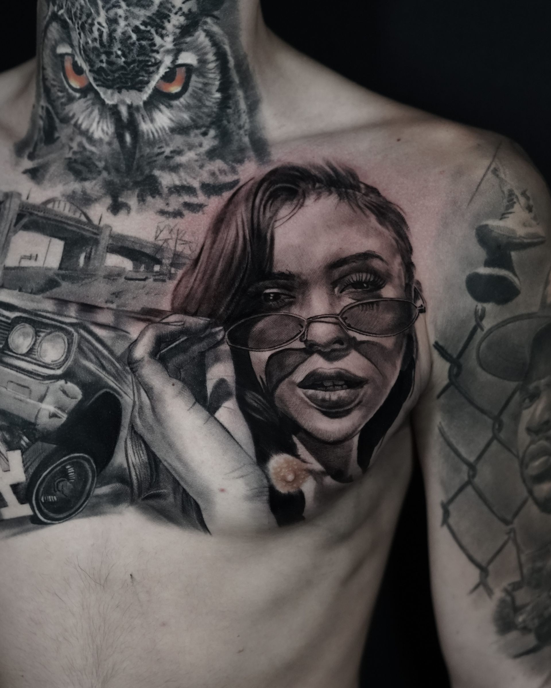 A man has a tattoo of a woman and an owl on his chest.