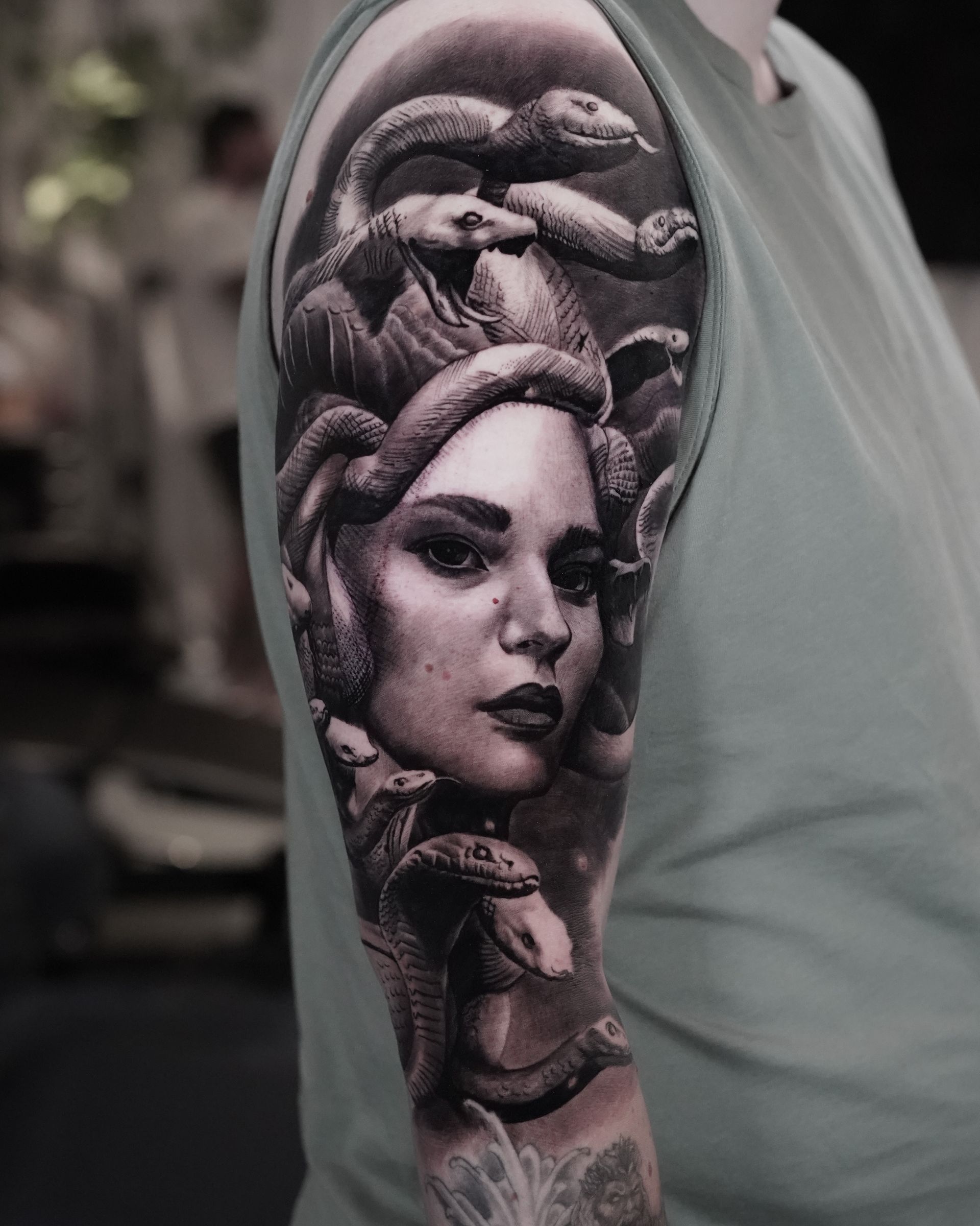 A man has a medusa tattoo on his arm.
