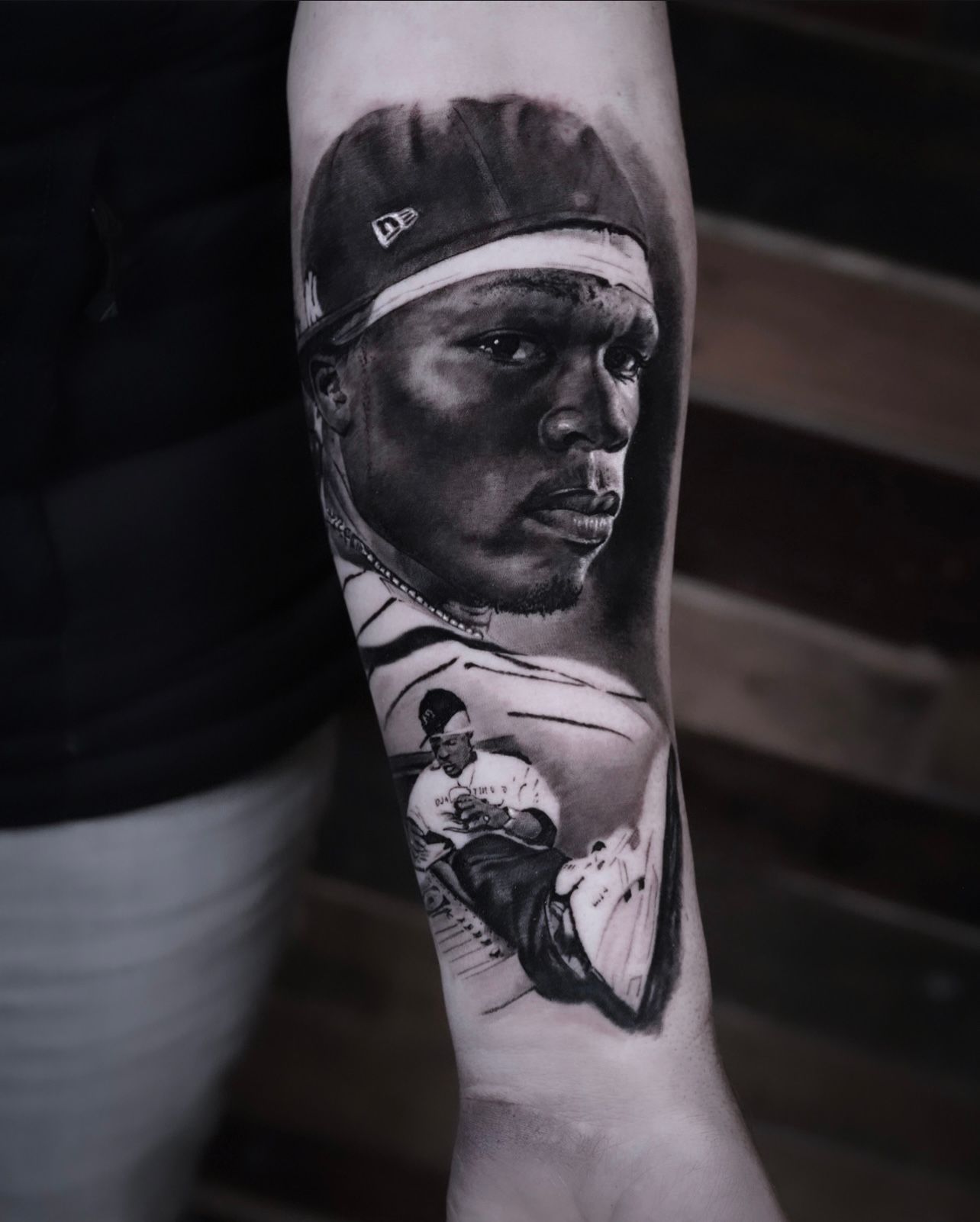 A man has a tattoo of a baseball player on his forearm.