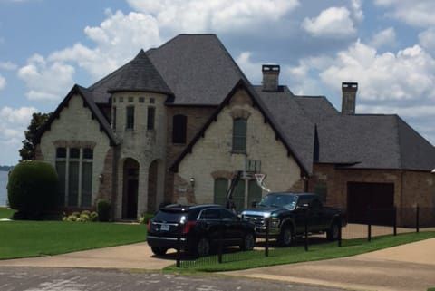 A large house with cars parked in front of it
