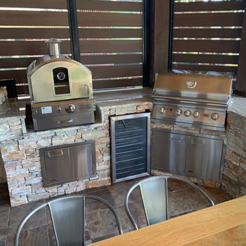 There is a pizza oven and a grill in the kitchen.