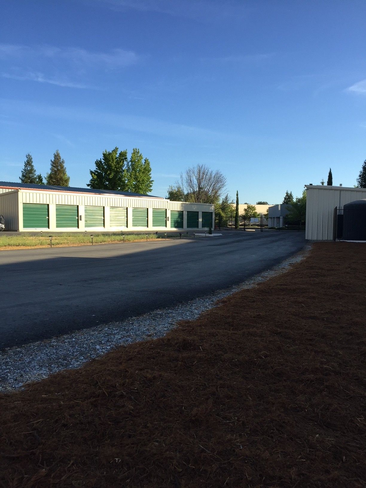 A row of storage units are lined up on the side of a road.