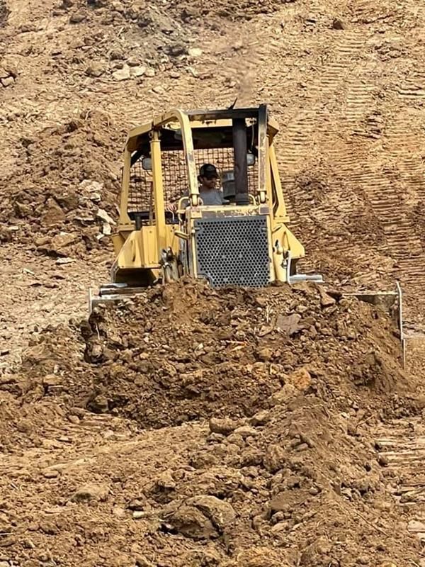 Bulldozer Is Driving Down A Dirt Hill — Milton, KY — B&N Land Management LLC