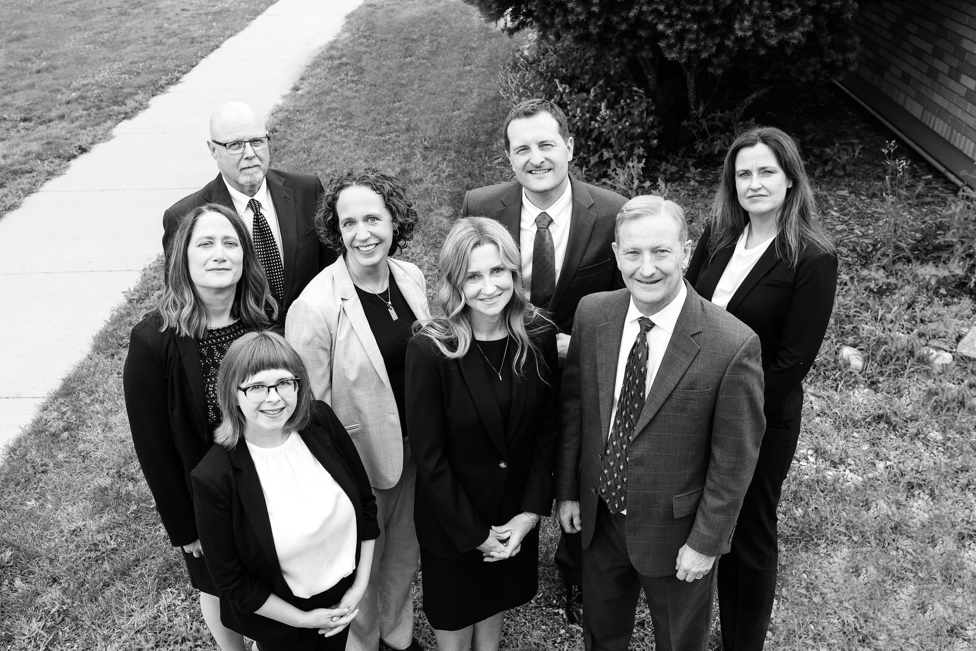 A black and white group photo of the firm's attorneys.