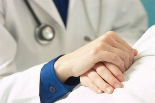 Doctor holding patient's hand — Clinics & Medical Centers in Philadelphia, PA