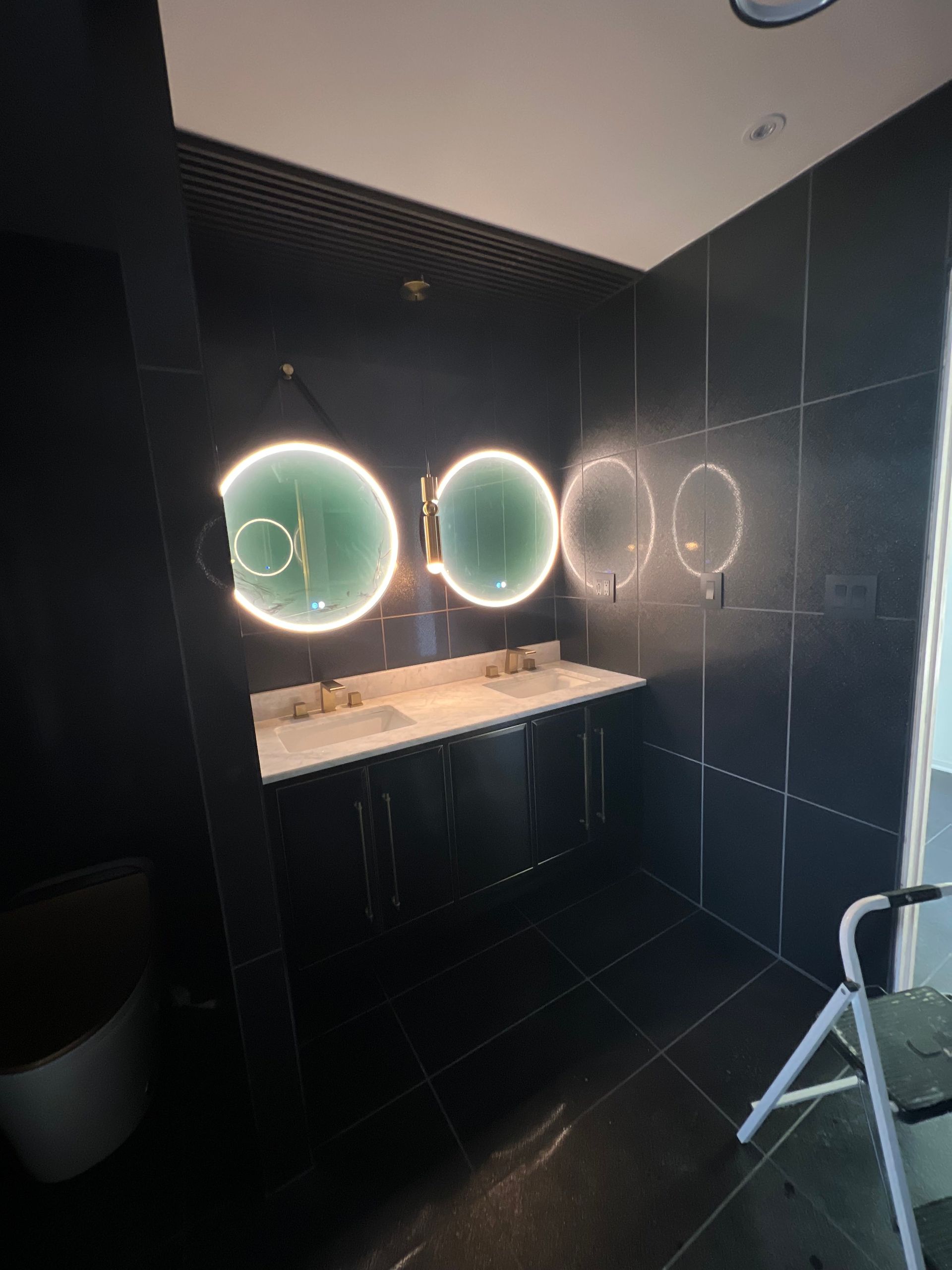 A bathroom with two sinks and a mirror on the wall.