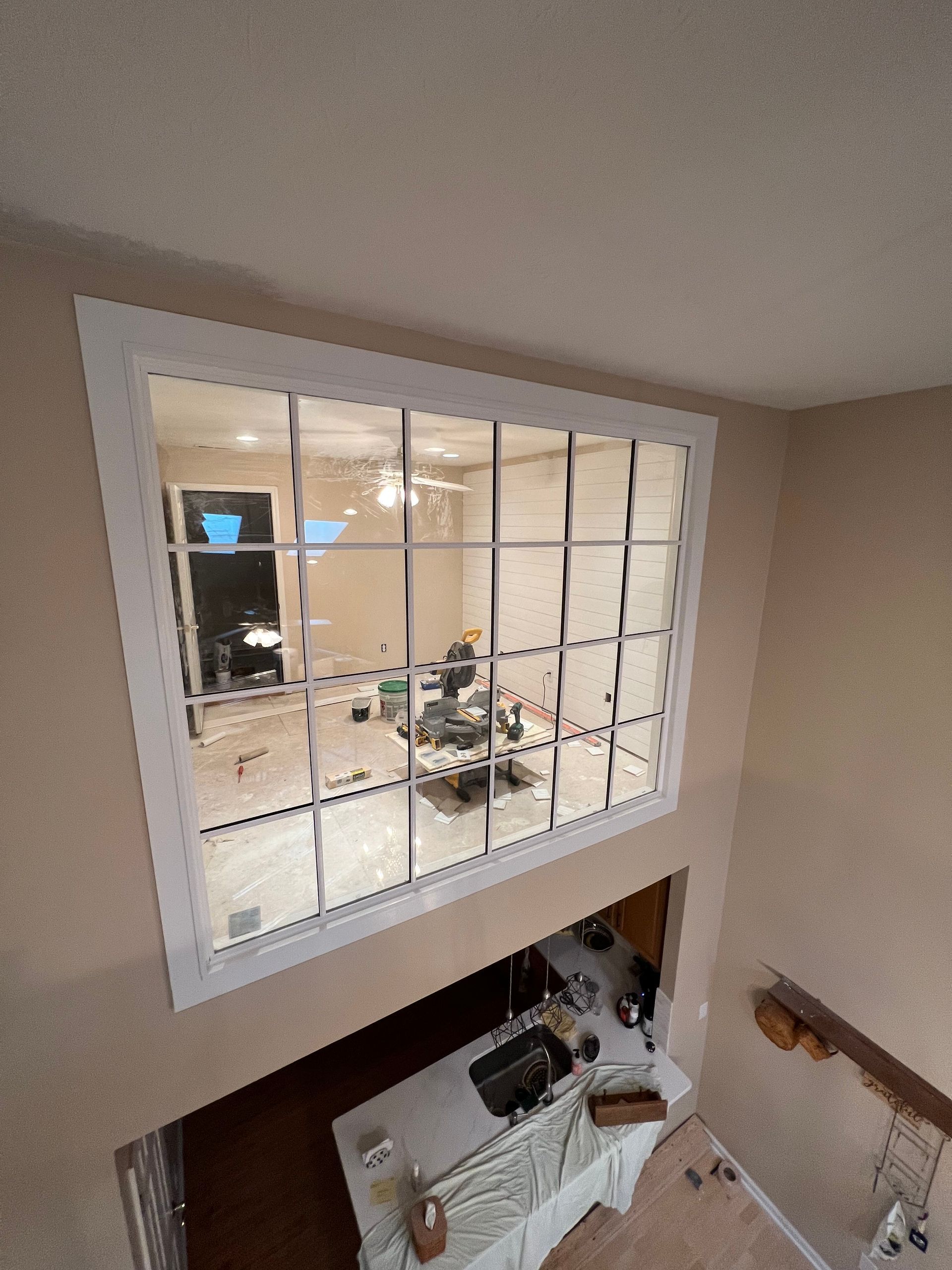 An aerial view of a kitchen with a large window.
