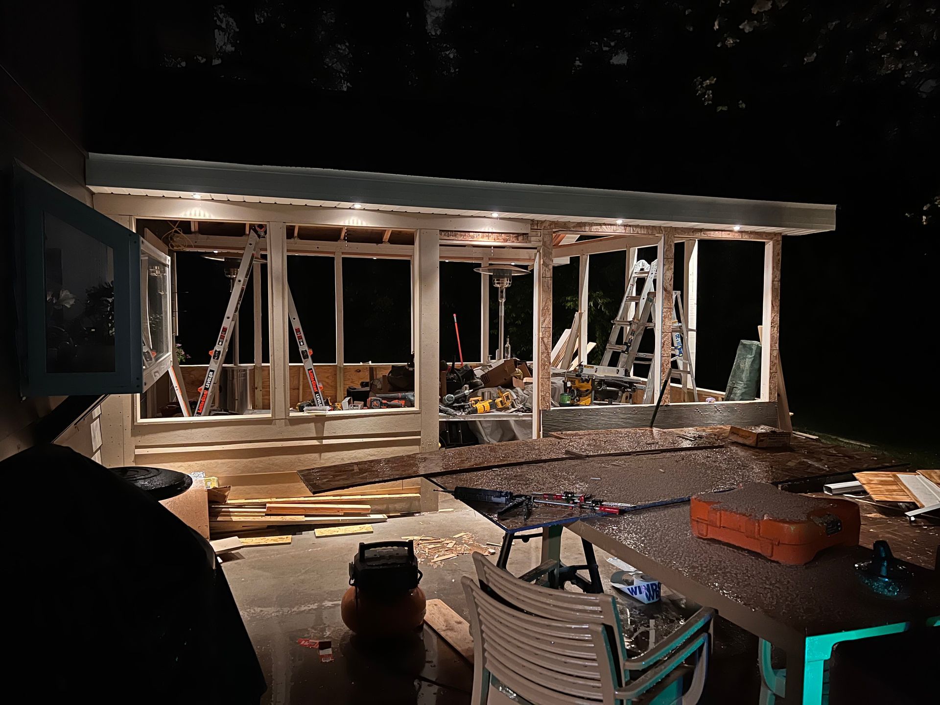 A house is being built at night with a lot of windows.