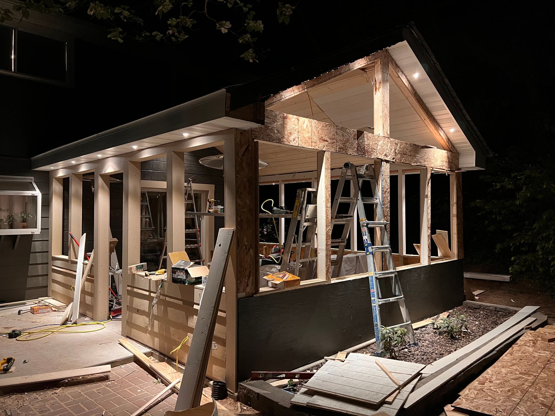 A house is being built at night with a lot of windows.