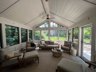 A living room filled with furniture and a ceiling fan.